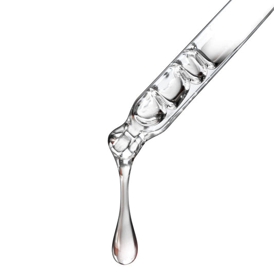 clear squalane facial oil dripping out of dropper